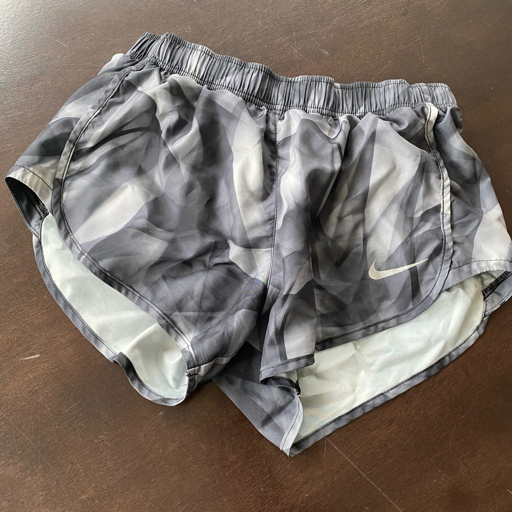 NIKE: PAIR OF TWO athletic shorts. Adjustable waistband and small pocket.